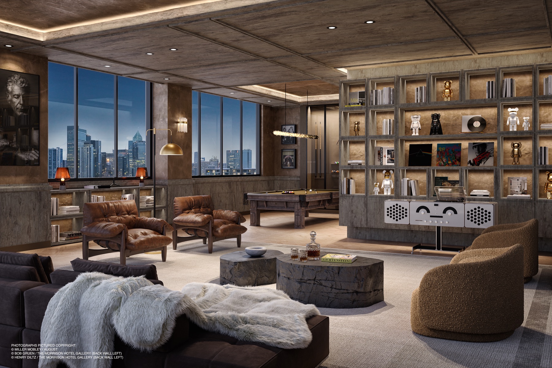 The VINYL resident lounge at The Rider Residences Wynwood — an industrial-luxe room with concrete and warm wood, a billiards table, leather armchairs, a sculptural Brionvega turntable, collectible art, and skyline views at dusk.
